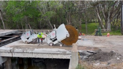 Crews sawcut and remove portions of the bridge on Tuesday, February 18, 2025.